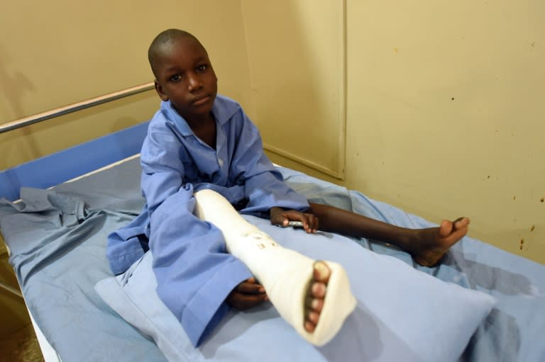 A boy, injured in a Boko Haram attack, sits on his bed in a hospital ward in Maiduguri, capital of northeast Nigerian Borno State