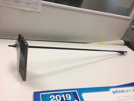 A supplied image obtained March 13, 2019 of a mobile phone pierced by an arrow. AAP Image/Supplied by NSW Police Force/via REUTERS