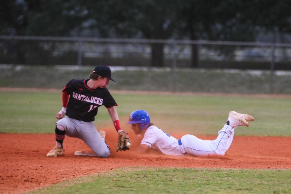 Park Vista outfielder Trent MacDougall (15) slides safely into second base as Santaluces short stop Keaton Kangas (10) attempts to tag him out during the Class 7A District 12 semifinal between host Santaluces and Park Vista in Lake Worth, FL., on Tuesday, May 3, 2022. Final score, Park Vista, 9, Santaluces, 6.