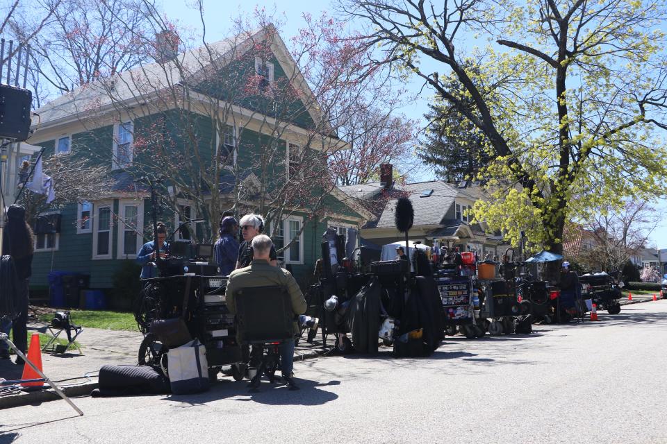 A movie production crew in Pawtucket is lined up outside the home of Lydia Breckon while the cast of "Ella McCay" films inside Monday afternoon. [Paul Edward Parker/The Providence Journal]