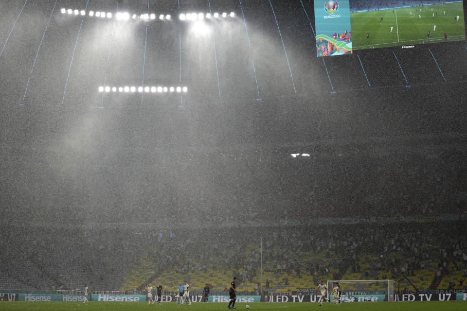 Heavy rain falls during the Euro 2020 soccer championship group F match between Germany and Hungary at the Allianz Arena in Munich, Germany, Wednesday, June 23, 2021. (AP Photo/Matthias Schrader, Pool)