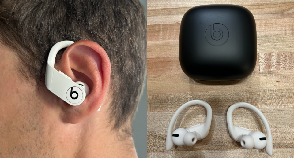 man wearing white Powerbeats Pro to man's ear and desk