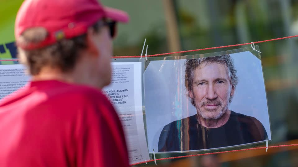 A man looks at the portrait of musician Roger Waters at a counter-event, which tries to present the singer's position, on the sidelines of a demonstration under the slogan "Frankfurt united against anti-Semitism". Waters is accused of using anti-Semitic tropes, which he denies.  - Andreas Arnold/picture alliance/Getty Images