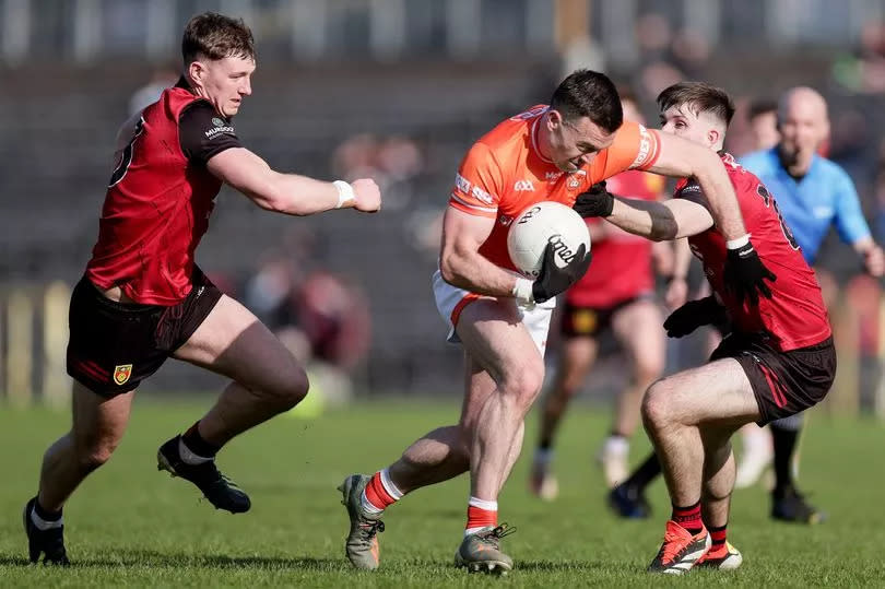 Armagh's Aidan Forker in action against Down's Ryan McEvoy and Peter Fagan
