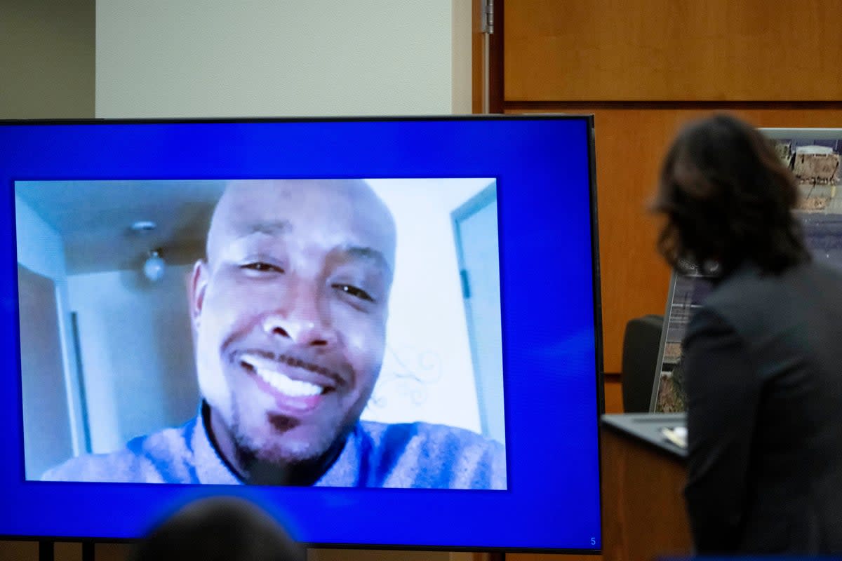 FILE - A photo of Manny Ellis is displayed while Special Assistant Attorney General Patty Eakes gives closing arguments during the trial of three Tacoma police officers in the killing of Ellis at Pierce County Superior Court, Dec. 11, 2023, in Tacoma, Wash.  (Brian Hayes / The News Tribune)