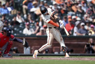 San Francisco Giants' Tyler Fitzgerald, right, singles in front of Washington Nationals catcher Drew Milas, left, during the sixth inning of a baseball game in San Francisco, Wednesday, April 10, 2024. (AP Photo/Jed Jacobsohn)
