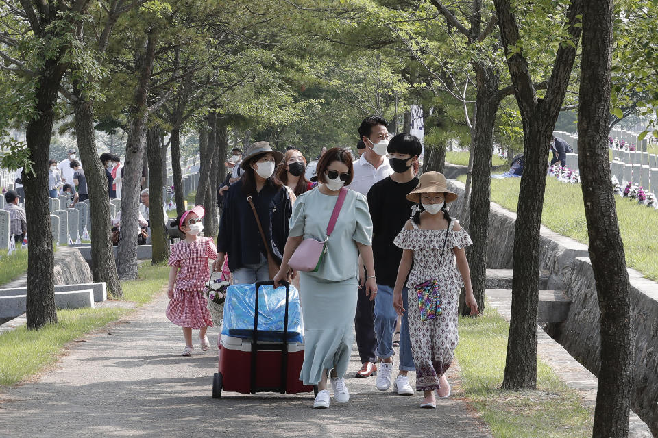 People wearing face masks to help protect against the spread of the new coronavirus visit to pay their respects on Memorial Day at the national cemetery in Seoul, South Korea, Saturday, June 6, 2020. (AP Photo/Ahn Young-joon)
