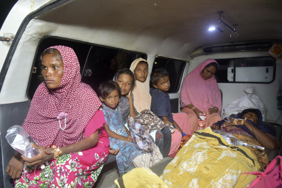 Ethnic Rohingya women and children sit inside an ambulance upon arrival at a temporary shelter after their boat landed in Pidie, Aceh province, Indonesia, Monday, Dec. 26, 2022. A second group in two days of weak and exhausted Rohingya Muslims landed on a beach in Indonesia's northernmost province of Aceh on Monday after weeks at sea, officials said. (AP Photo/Rahmat Mirza)