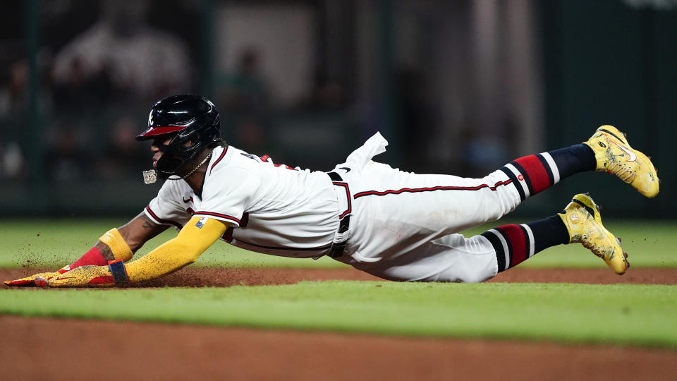 Atlanta Braves' Ronald Acuna Jr. slides into second base on an unsuccessful steal-attempt in the third inning of a baseball game against the Washington Nationals, Monday, Sept. 19, 2022, in Atlanta. (AP Photo/John Bazemore)