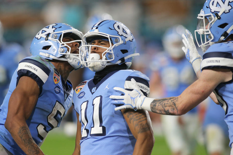 Jan 2, 2021; Miami Gardens, FL, USA; North Carolina Tar Heels wide receiver <a class="link " href="https://sports.yahoo.com/nfl/players/40126" data-i13n="sec:content-canvas;subsec:anchor_text;elm:context_link" data-ylk="slk:Josh Downs;sec:content-canvas;subsec:anchor_text;elm:context_link;itc:0">Josh Downs</a> (11) celebrates with teammates after scoring a touchdown against the Texas A&M Aggies in the fourth quarter of the game at Hard Rock Stadium. Mandatory Credit: Sam Navarro-USA TODAY Sports