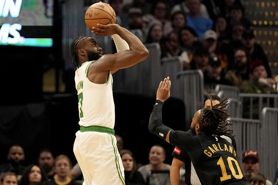 Boston Celtics guard Jaylen Brown (7) shoots over Cleveland Cavaliers guard Darius Garland (10) in the first half of an NBA basketball game, Tuesday, March 5, 2024, in Cleveland. (AP Photo/Sue Ogrocki)