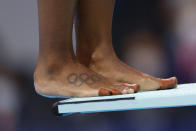 <p>A tattoo of the Olympic rings is pictured on the foot of Canada's Jennifer Abel as she prepares to compete in the women's synchronised 3m springboard diving final event during the Tokyo 2020 Olympic Games at the Tokyo Aquatics Centre in Tokyo on July 25, 2021. (Photo by Odd ANDERSEN / AFP) (Photo by ODD ANDERSEN/AFP via Getty Images)</p> 