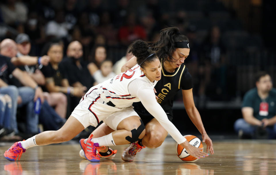 Washington Mystics forward Alysha Clark (22) and Las Vegas Aces forward Dearica Hamby, right, fight for the ball during the first half of a WNBA basketball game Saturday, June 25, 2022, in Las Vegas. (Steve Marcus/Las Vegas Sun via AP)