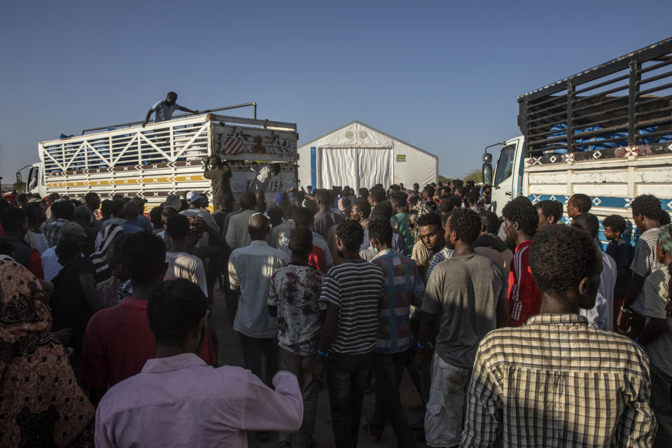 Tigray refugees who fled the conflict in Ethiopia's Tigray region, wait to receive aid at Umm Rakouba refugee camp in Qadarif, eastern Sudan, Tuesday, Nov. 24, 2020. (AP Photo/Nariman El-Mofty)