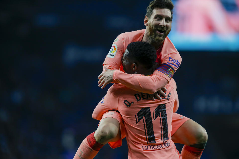 FC Barcelona's Lionel Messi celebrates with teammate Ousmane Dembele during the Spanish La Liga soccer match between Espanyol and FC Barcelona at RCDE stadium in Cornella Llobregat, Spain, Saturday, Dec. 8, 2018. (AP Photo/Joan Monfort)