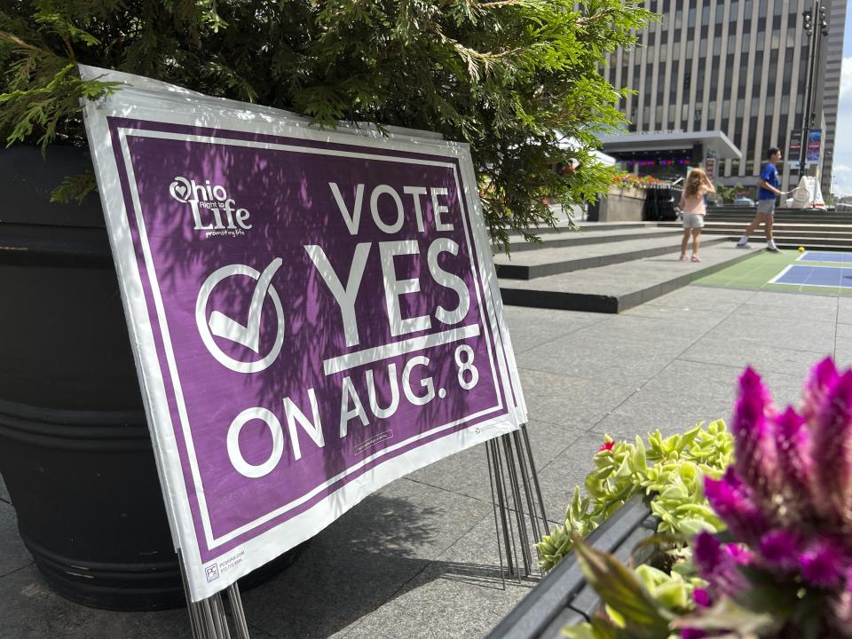 A sign sits in Fountain Square asking Ohioans to vote in support of Issue 1 during an event hosted by Created Equal on Thursday, July 20, 2023, in Cincinnati, Ohio. The fraught politics of abortion have helped turn an August ballot question in Ohio that would make it harder to change the state constitution into a cauldron of misinformation, fear-mongering and vitriol. (AP Photo/Patrick Orsagos)