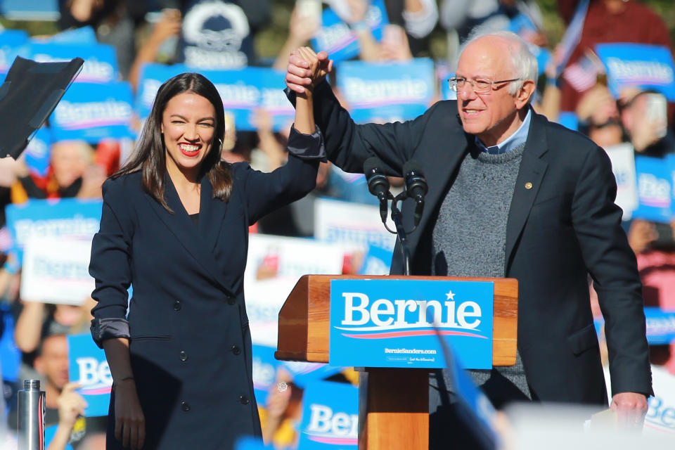 U.S. Representative Alexandria Ocasio-Cortez, Democrat of New York, clasps hands with Vermont senator and Democratic presidential candidate Bernie Sanders at the Bernie's Back Rally in Long Island City, New York on Saturday, Oct. 19, 2019. (Photo: Gordon Donovan/Yahoo News)