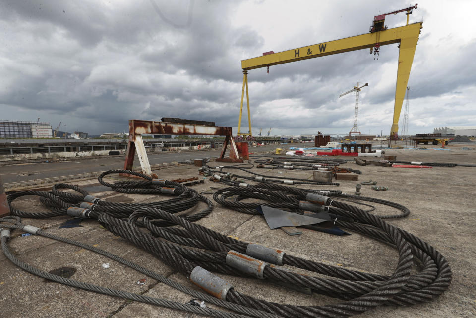 Cables are strewn over the ground in front of the Samson Crane at the Harland and Wolff shipyard after workers voted to continue their occupation of the shipyard, in Belfast, Northern Ireland, Monday Aug. 5, 2019. Harland and Wolff, which is one of Northern Ireland's most historic brands with credits including for building the RMS Titanic, is facing closure after its trouble-hit Norwegian parent company Dolphin Drilling failed to find a buyer. (Liam McBurney/PA via AP)