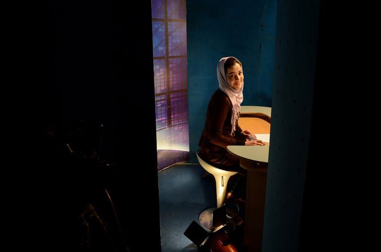 A news presenter prepares to read the news at a studio in Kabul on January 30, 2013. Afghanistan's first Internet TV station tackles subjects that the mainstream channels prefer to ignore