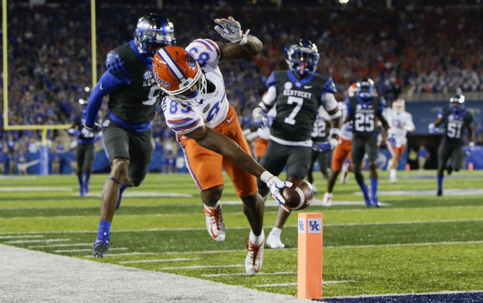 Florida wide receiver Tyrie Cleveland reaches for the goal line in front of Kentucky cornerback Derrick Baity, left, and safety Mike Edwards to score a touchdown during the first half of an NCAA college football game Saturday, Sept. 23, 2017, in Lexington, Ky. (AP Photo/David Stephenson)