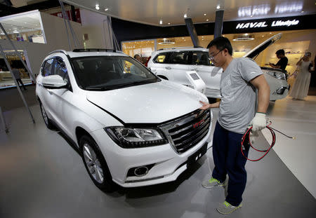 A staff member checks a Haval H2 from Great Wall Motors during the Auto China 2016 auto show in Beijing, China May 4, 2016. REUTERS/Jason Lee