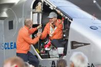 Solar Impulse 2 pilot Bertrand Piccard (L) greets his pilot Andre Borschberg, after Borschberg landed at Kalaeloa Airport, Hawaii, on July 3, 2015