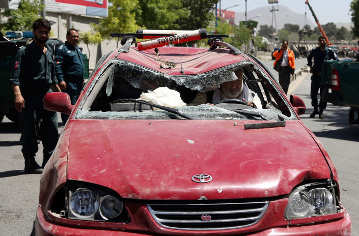 <p>An Afghan man drives his damaged car after a suicide attack in Kabul, Afghanistan, Wednesday, May 31, 2017. (AP Photos/Rahmat Gul) </p>