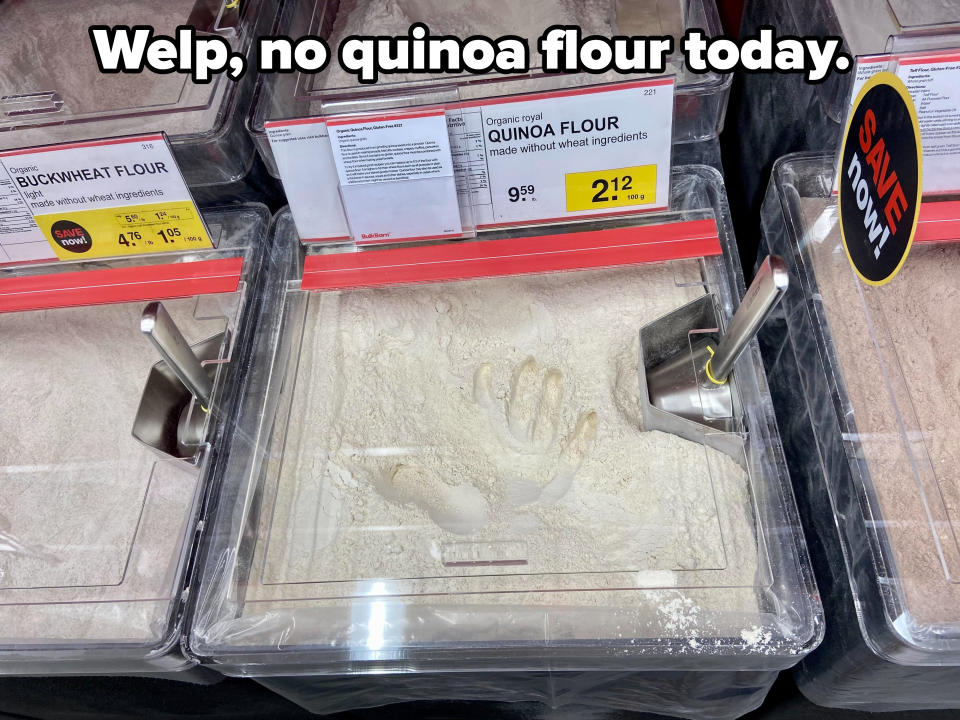 A handprint in a bin of quinoa flour at the store, with the caption "Welp, no quinoa flour today"