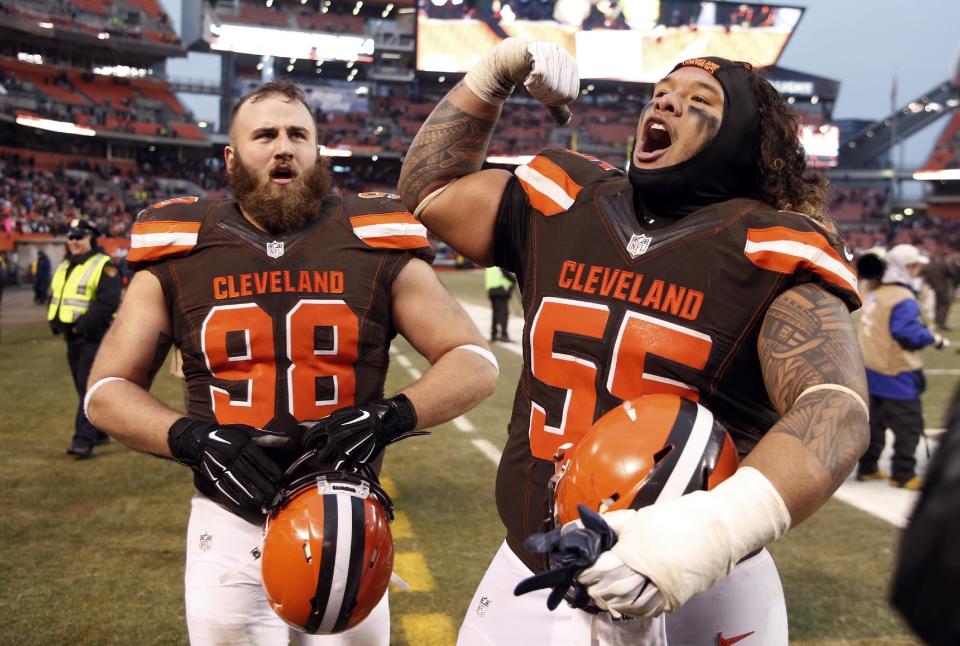 Cleveland Browns nose tackle Danny Shelton (55) and Jamie Meder (98) celebrate after a win over San Diego Chargers in an NFL football game, Saturday, Dec. 24, 2016, in Cleveland. (AP Photo/Ron Schwane)