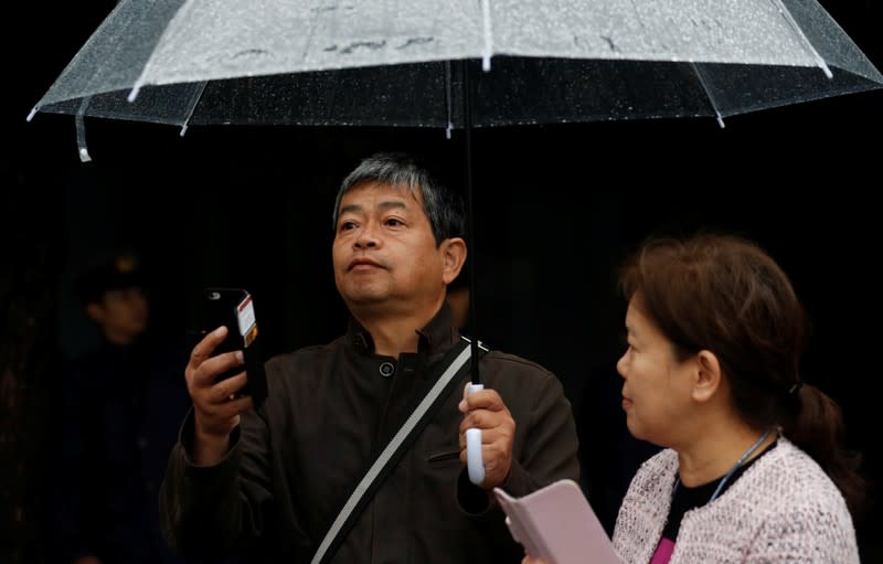 Well-wishers watch as Japan's Empress Masako arrives at the Imperial Palace on the day Emperor Naruhito is formally enthroned, in Tokyo