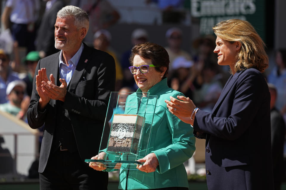 Tennis legend Billie Jean King of the U.S. poses with tournament director Amelie Mauresmo of France, right, and French Tennis Federation president Gilles Moretton, left, during a ceremony marking the 50th anniversary of her Roland Garros win at the French Open tennis tournament in Roland Garros stadium in Paris, France, Thursday, June 2, 2022. (AP Photo/Michel Euler)