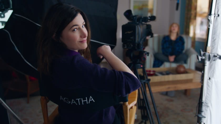 Kathryn Hahn looks over the back of a director's chair that says, Agatha