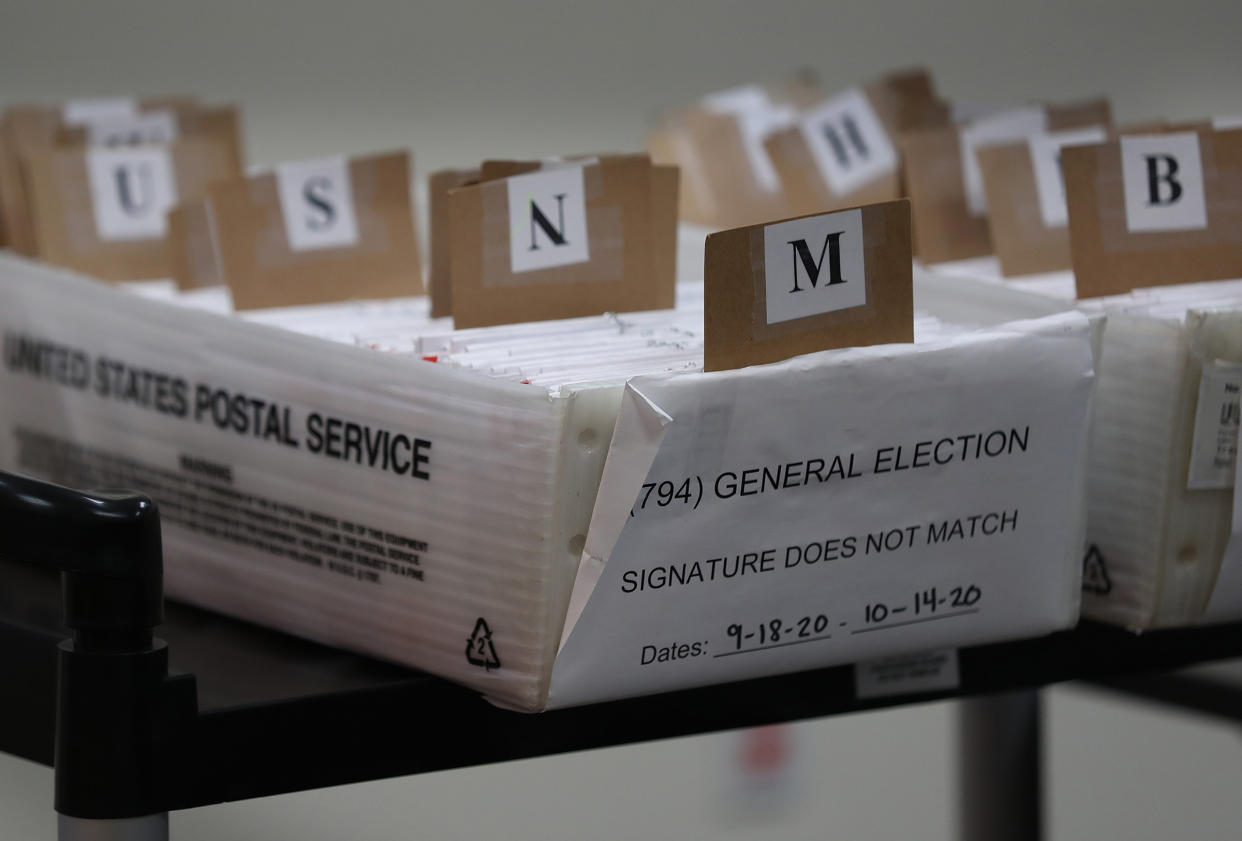 Boxes for Vote-by-Mail ballots that need to be reviewed due to signature discrepancies are seen ahead of the Nov. 3rd general election at the Miami-Dade County Elections Department on Oct. 15 in Doral, Florida