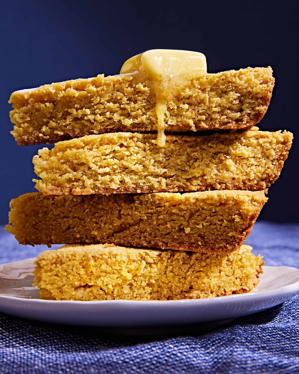stack of cornbread topped with a pat of butter