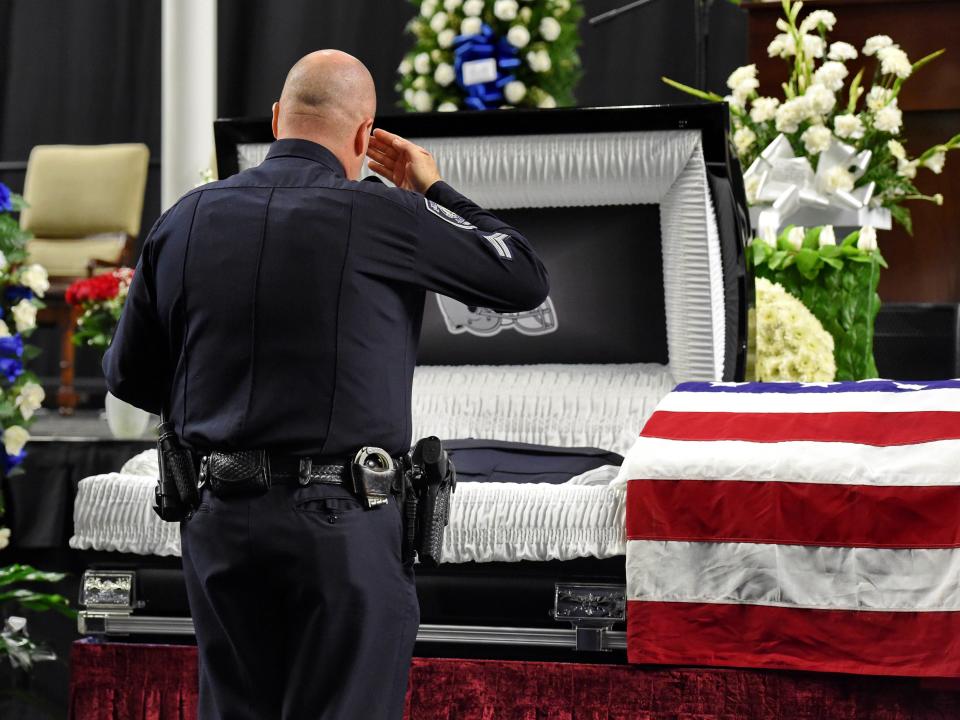 In this Oct. 8, 2018, file photo, mourners and police officers from around the country attend a memorial service before the funeral for fallen Florence police officer Sgt. Terrence Carraway at the Florence Center in Florence, S.C. Sgt. Carraway was killed in the line of duty Wednesday, Oct. 3, 2018. More police officers have died in the line of duty this year than in 2017, according to data compiled by the National Law Enforcement Officers Memorial Fund.