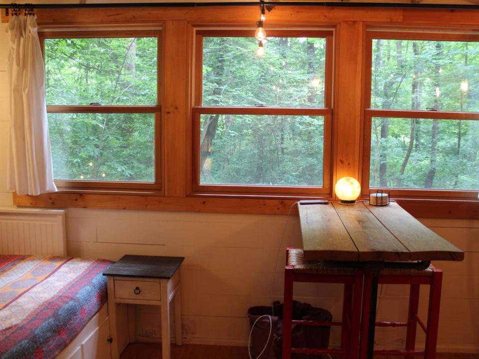 tiny house interior view through the windows into the woods