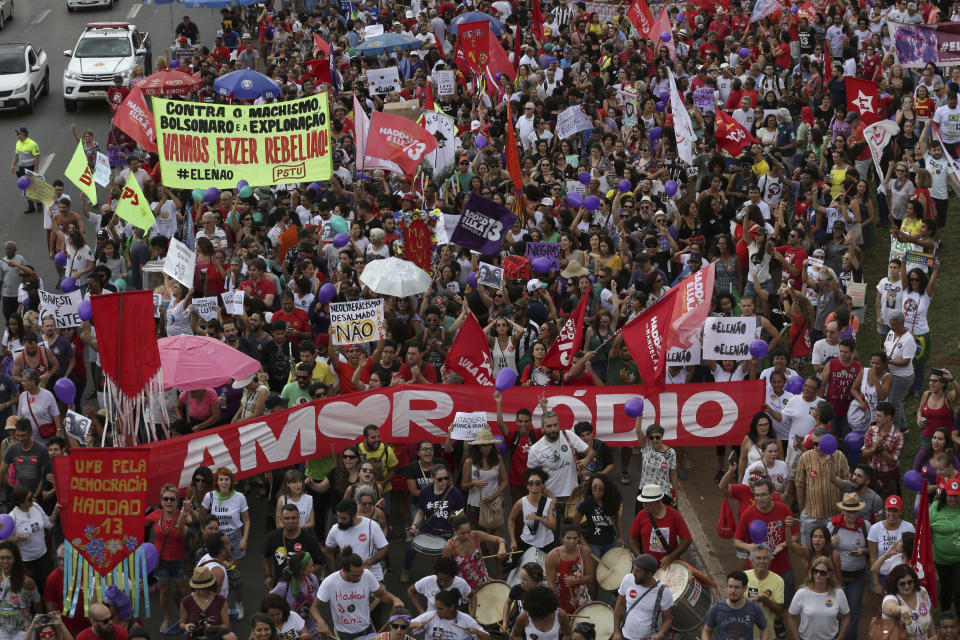 With a banner in Portuguese that reads "More Love and Less Hatred," hundreds of demonstrators marched during a protest called "Women against Bolsonaro," in Brasilia, Brazil, Saturday, Oct. 20, 2018. Women and left-wing militants held protests across the country against the right-wing presidential candidate Jair Bolsonaro. (AP Photo/Eraldo Peres)