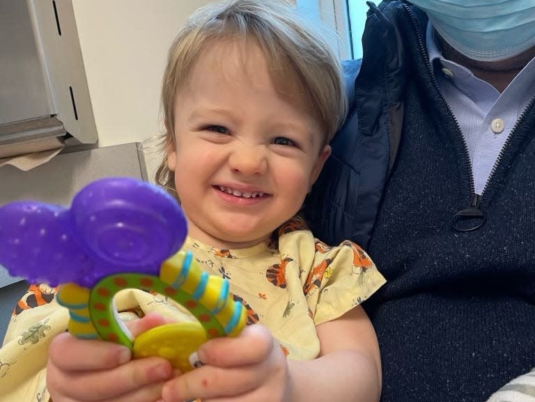 Three-year-old Henry Saladino holding a stroller toy.