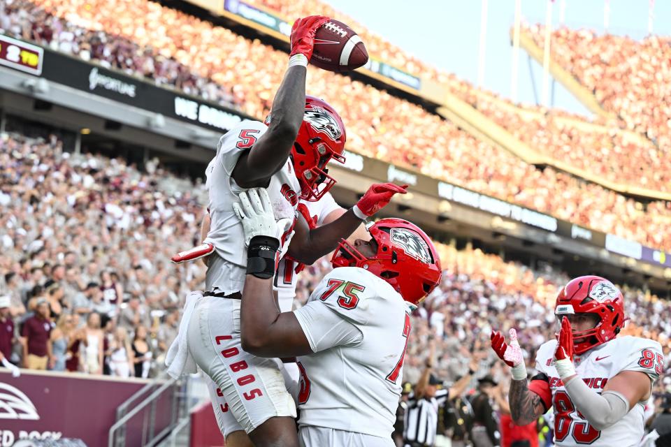 Sep 2, 2023; College Station, Texas, USA; New Mexico Lobos running back Jacory Croskey-Merritt (5) celebrates his touchdown with teammate offensive lineman J.C. Davis (75) during the second quarter against the Texas A&M Aggies at Kyle Field. Mandatory Credit: Maria Lysaker-USA TODAY Sports