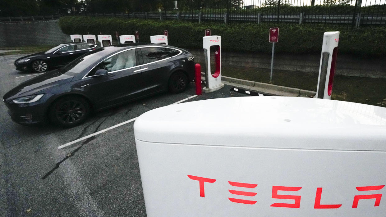 A Tesla vehicles charge, Wednesday, Sept. 27, 2023, in Woodstock, Ga. (AP Photo/Mike Stewart)