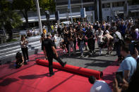 Crew members install the red carpet at the Palais des Festivals ahead of the opening day of the 75th international film festival, Cannes, southern France, Tuesday, May 17, 2022. The Cannes film festival runs from May 17 until May 28 2022. (AP Photo/Daniel Cole)