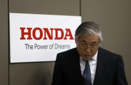 Tetsuo Iwamura, Executive Vice President of Honda Motor Co, walks into a news conference at the company's headquarters in Tokyo October 28, 2014. Honda Motor Co Ltd cut its sales forecasts for this year citing competition in Japan and China as well as the impact of recalls on new model launches, but said a weak yen will help it stick to its operating profit estimate at 770 billion yen. REUTERS/Yuya Shino