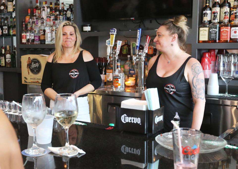 Greg's Bistro bartenders Reese Carson, left, and Jennifer Morin share an emotional moment Wednesday, June 28, 2023, as Morin welcomes Carson back to work behind the bar after an accident at the Hampton eatery in 2022.