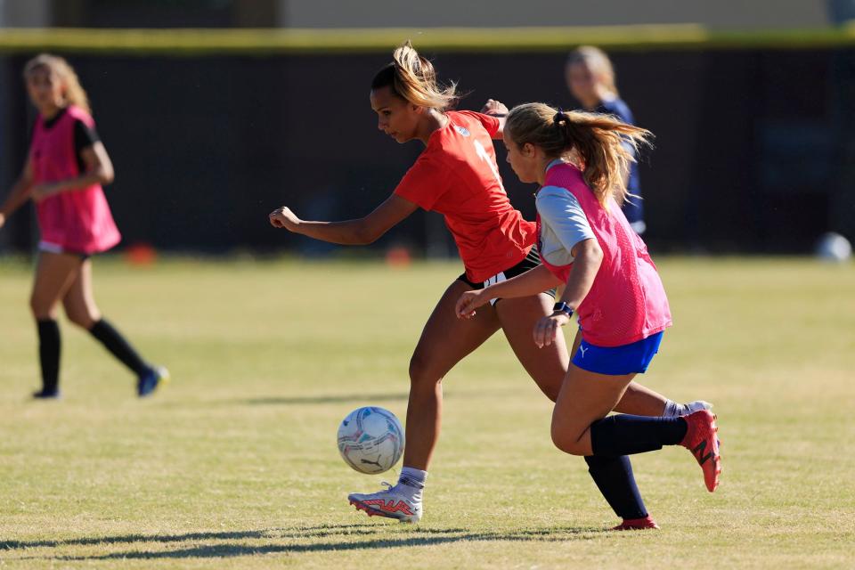 Gaby Rourke (center) dribbles during Atlantic Coast soccer practice. The senior, committed to Kentucky, is an all-conference athlete both in the field and at goalkeeper.