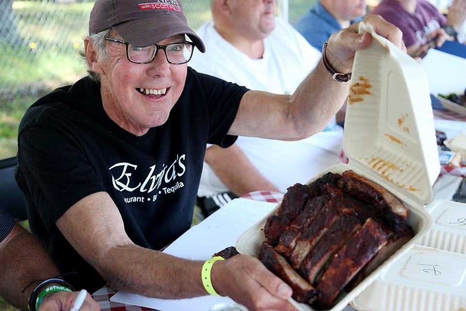 Dan Naples shows off some of the ribs that he and the other judges are trying out during the 13th Marshfield Community Rib Cook-Off at the Marshfield Fairgrounds on Saturday, Sept. 11, 2021.