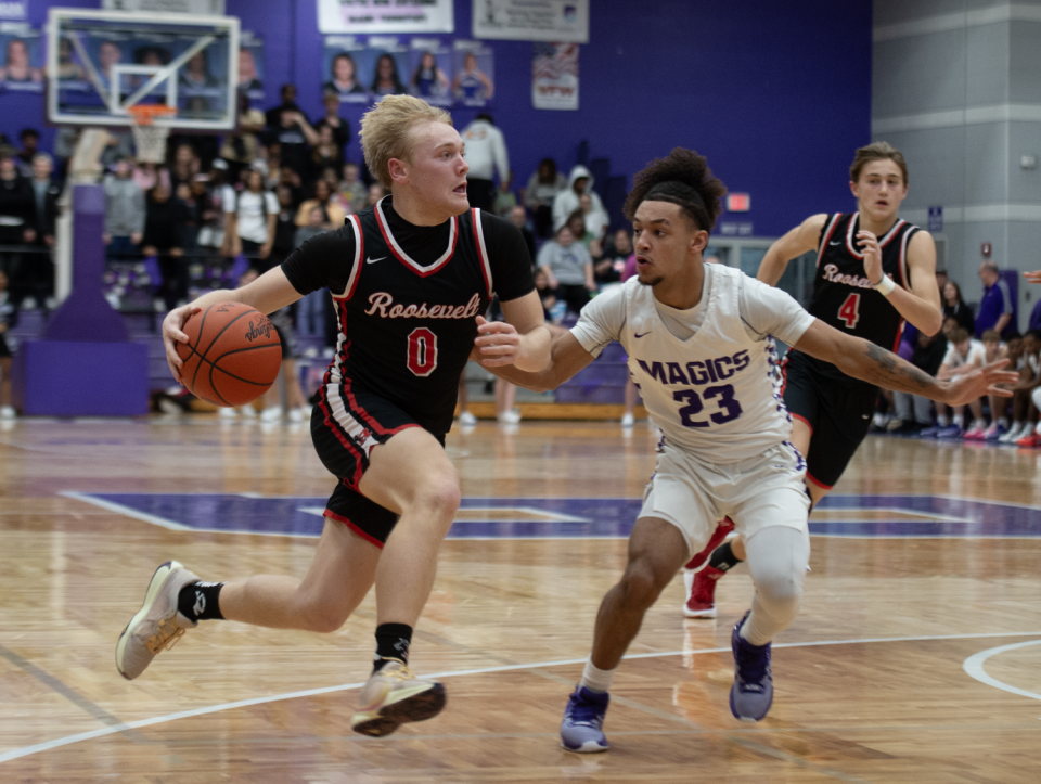 Kent Roosevelt's Jack Smith looks to make a play as Barberton's Kenneth Larry defends on Feb. 9, 2024.