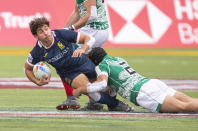 Spain's Mana Williams, left, is tackled by Mexico's Ricardo Ancira during an HSBC Canada Sevens quarterfinal rugby match in Edmonton, Alberta, Sunday, Sept. 26, 2021. (Jason Franson/The Canadian Press via AP)