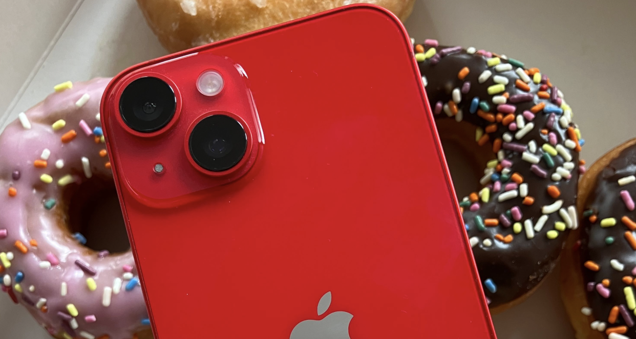  A red iPhone with donuts in the background. 