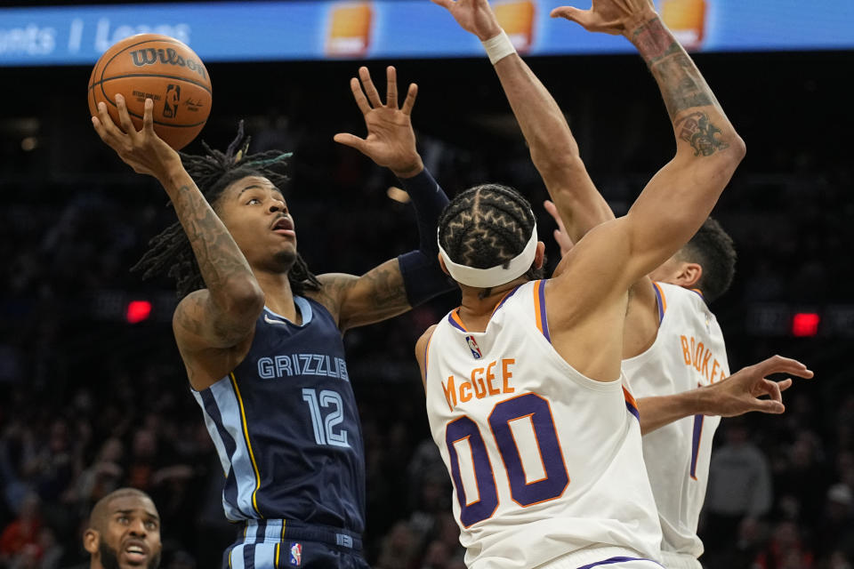 Memphis Grizzlies guard Ja Morant (12) during the first half of an NBA basketball game against the Phoenix Suns, Monday, Dec. 27, 2021, in Phoenix. (AP Photo/Rick Scuteri)