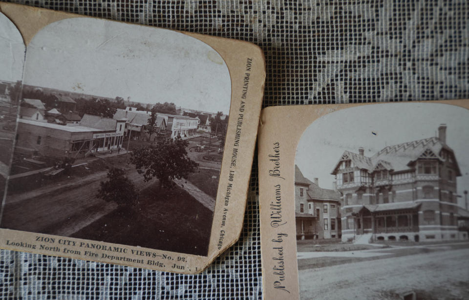 Old photographs of Zion sit on display in the Historic Shiloh House, John Alexander Dowie's former home, restored and preserved by the Zion Historical Society, in Zion, Ill., on Saturday, Sept. 17, 2022. (AP Photo/Jessie Wardarski)